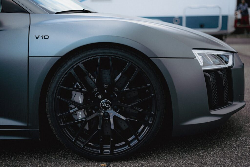 a grey sports car parked in a parking lot